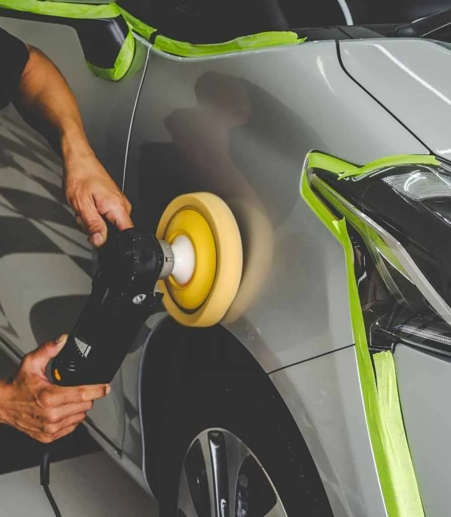 Car paint being buffed with a polisher
